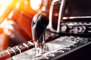 Modern araba otomatik vites kolu yakın çekim. navigasyon ve multimedya düğmeleri denetler. Araba iç ayrıntılar. İletim üst karakter.