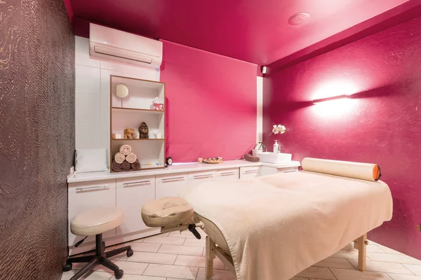 Massage room interior design in wellness and spa center. Dim lighting