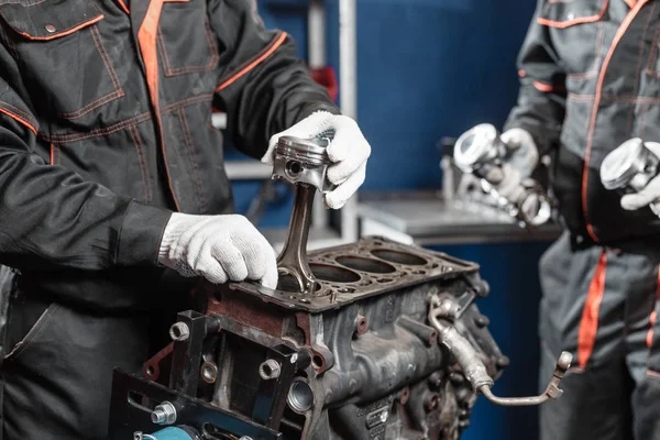 O mecânico instala um novo pistão. Desmontar o veículo de bloco do motor. Reparação de capital automóvel. 16 válvulas e quatro cilindros. Conceito de serviço de carro . — Fotografia de Stock