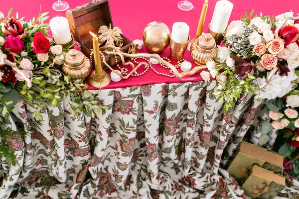 Interior of a wedding tent decoration ready for guests. Served round banquet table outdoor in marquee decorated flowers and silk. Catering concept