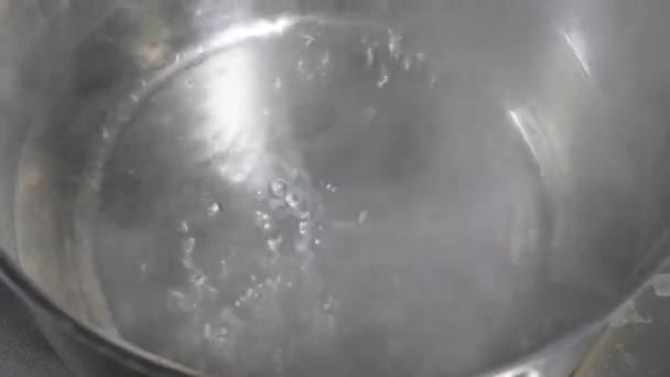 Kokend water in de pan op elektrisch fornuis in de keuken van restaurant. in een RVS-pan. — Stockvideo