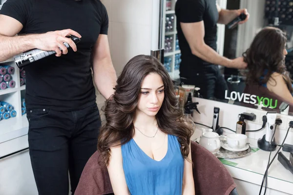 Portre Kuaför adam genç kadın saç güzellik salonunda yapar. — Stok fotoğraf