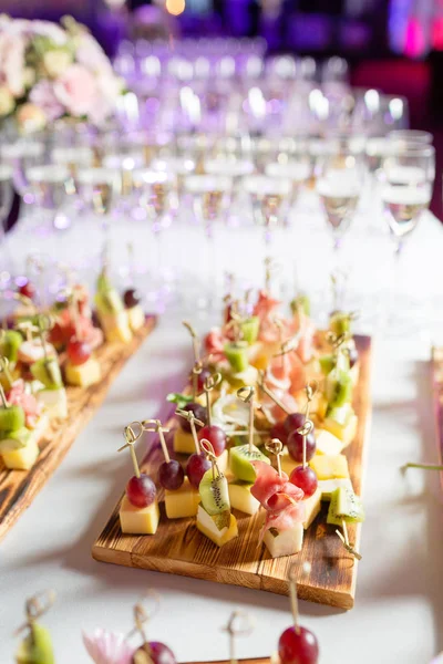 Furshet. Table top full of glasses of sparkling white wine with canapes and antipasti in the background. champagne bubbles — Stock Photo, Image