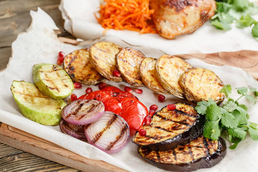 grilled vegetables. Serving on a wooden Board on a rustic table. Barbecue restaurant menu, a series of photos of different dishes