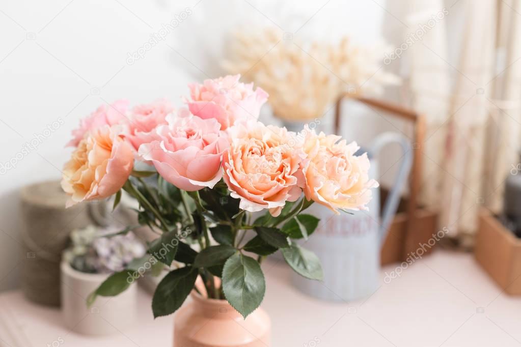 Bouquet flowers of pink roses in glass vase. Shabby chic home decor. florist at a flower shop.