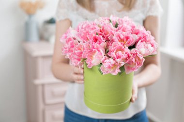 Güneşli bahar sabahı. Pembe Lale güzel bir grup ellerinde tutan genç mutlu kadın. Gülümsüyor kız için hediye. Headbox çiçek buketi