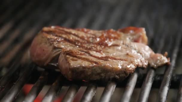 Att steka biff på bbq. Typiska argentinska Grill eller asado. Brinnande ved i grillen och röda glödande kol. — Stockvideo