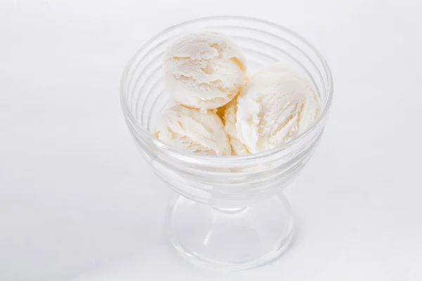 Vanilla ice cream on white background. Scoops of vanilla ice cream in glasses bowl