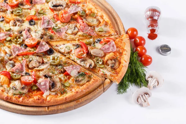 Italian kitchen and cooking concept. Hot tasty sliced with ham, sausage, jalapenos, mushrooms, tomato. Eat delivery concept.