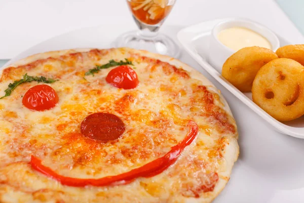 Pizza smiling. Italian dish with tomato sauce smile and parmesan cheese, fresh tomatoes, basil.