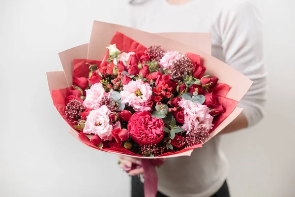Bouquet of beautiful flowers in womens hands. Floristry concept. Spring colors. the work of the florist at a flower shop. Horizontal photo — Stock Photo, Image