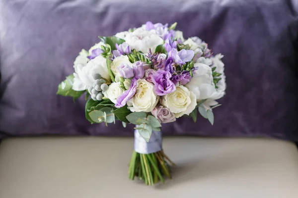 Brides wedding bouquet with peonies, freesia and other flowers on gray arm chair. Light and lilac spring color. Morning in room — Stock Photo, Image