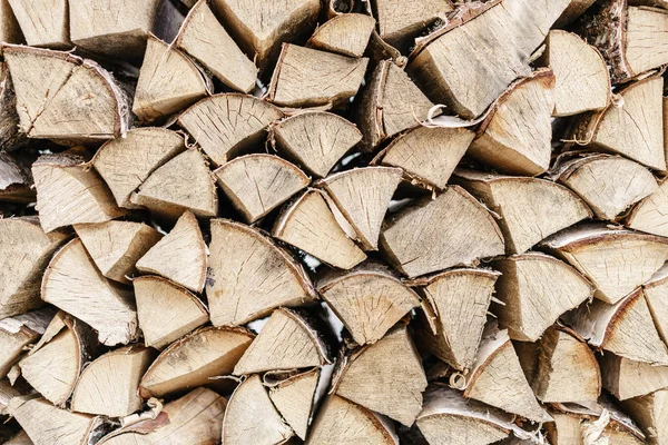 Horizontal wide photo wooden boards, birch and other trees for heating of the house in winter. The palette of fresh lumber. Firewood for heating in agriculture.