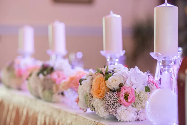 Velas blancas en metal candelabro de oro de pie sobre mesas en la recepción de la boda de lujo en el restaurante. decoración elegante y adorno — Foto de Stock