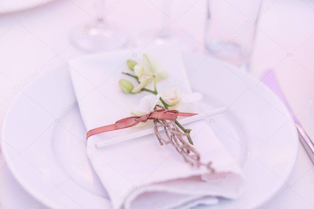 Empty plate with a napkin. Luxury wedding reception in restaurant. stylish decor and adorning. Restaurant table with food