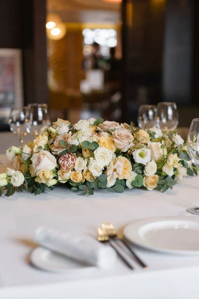 Luxury wedding reception. Flower arrangement on table in restaurant. Stylish decor and adorning.