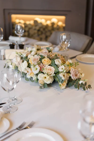 Luxury wedding reception. Flower arrangement on table in restaurant. Stylish decor and adorning.