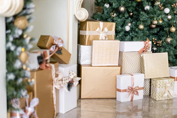 Sok karácsonyi ajándék alatt fa díszek. Karácsonyi bálok, szalagíjak, hópelyhek, fenyőtobozok és fények. — Stock Fotó