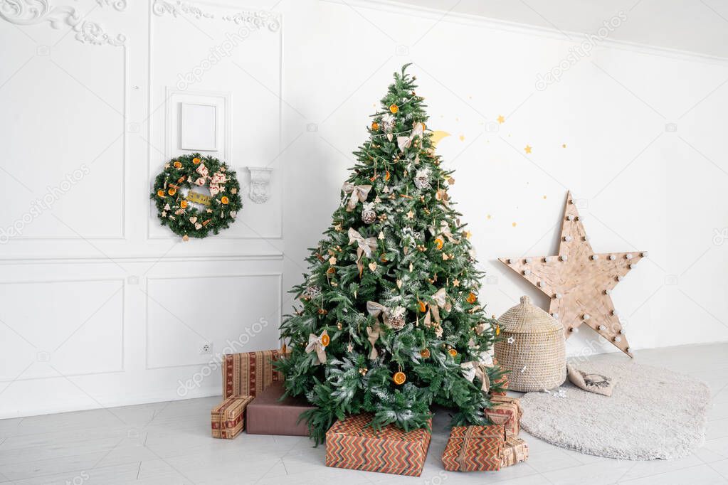 Childrens room with decorated christmas tree and presents. Christmas morning. White room with stucco.