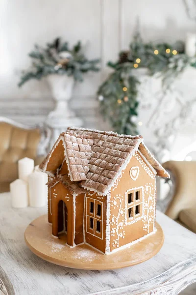 Postcard gingerbread house. Defocused lights of Christmas tree. Holiday mood. Christmas and Happy new year.