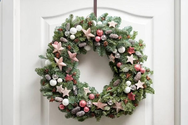 Hermosa corona de Navidad de abeto fresco en la puerta blanca. Entrada a la casa. Humor de Navidad. Árbol de Navidad . — Foto de Stock