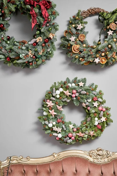 Três belas grinaldas festivas de abeto fresco na parede cinza. Humor de Natal. Árvore natal . — Fotografia de Stock