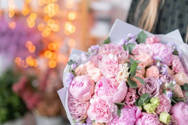 Pembe şakayıklar, Sarah Bernhardt ve farklı çiçekler. Avrupa çiçekçisi. Kadınların elinde güzel bir buket. Çiçekçi dükkanındaki çiçekçinin işi. Taze kesilmiş çiçek getirdim..