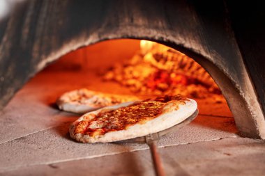 Napoli restoranında geleneksel ahşap fırında margherita pizza pişirdim. Orijinal Napoli pizzası. Kırmızı sıcak kömür.