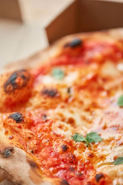 Pizza Margarita. Baked tasty margherita pizza in Traditional wood oven in Neapolitan restaurant, Italy.