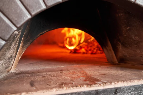 Горить дрова, плита нагрівається. Червоне гаряче вугілля. Традиційна дерев'яна піч в ресторані Неаполя, Італія. Оригінальна неаполітанська піца. — стокове фото