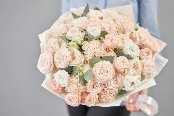 Mono bouquet of spray roses. Delicate bouquet of mixed flowers in womans hands. the work of the florist at a flower shop. Delicate Pastel color. Fresh cut flower. — ストック写真