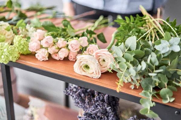 Education in the school of floristry. Master class on making bouquets. Summer bouquet. Learning flower arranging, making beautiful bouquets with your own hands. Flowers delivery
