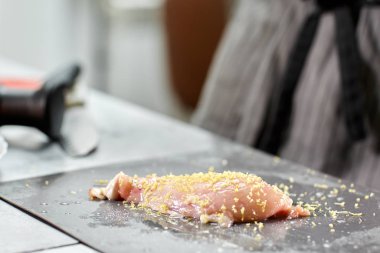 Şef tavuk doğrayıp terbiye ediyor. Restoran mutfağında profesyonel bir aşçı..