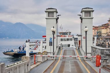 Bellagio, Province of Como Italy - January 19 2019: Ferry boat midway to Bellagio on the Lake Como at Winter cloudy day.