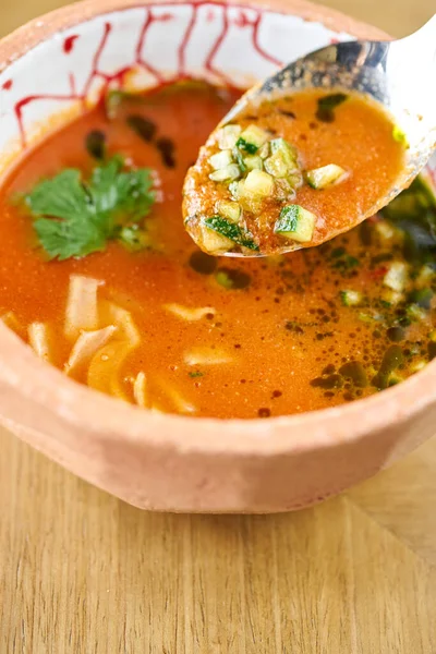Gaspacho soup in bowl. Traditional spanish cold soup puree gaspacho or gazpacho on wooden table