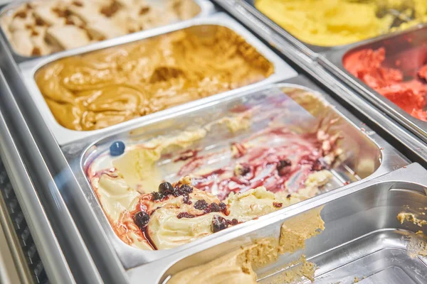 Fruit and cherry Gelato. Flavors various ice cream in Rome, Italy. Italian gelateria. Assortment of colorful gelato on cafe showcase. Natural fresh ice cream.