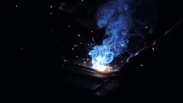 Welder working with welding machine. Bright flashes and smoke.. Welding of rebar and reinforcing mesh. for concrete reinforcement. House-building plant. Industrial interior. Concrete plant. — Stock Video