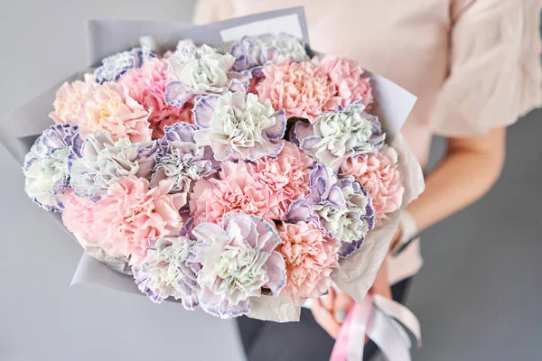 Bouquet von Nelkenblüten Pastellfarbe. Frühlingsstrauß in Frauenhand. Geschenk zum Muttertag. — Stockfoto