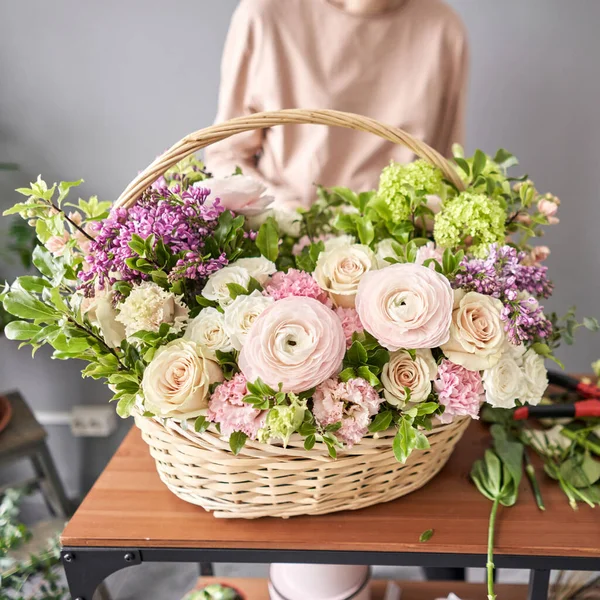 Woman florist creating beautiful bouquet in flower shop. Work in flower shop. Flowers delivery.