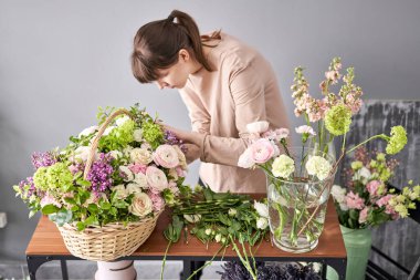 Çiçekçide çiçek buketi yapan kadın. Çiçekçide çalışıyorum. Çiçek teslimatı.