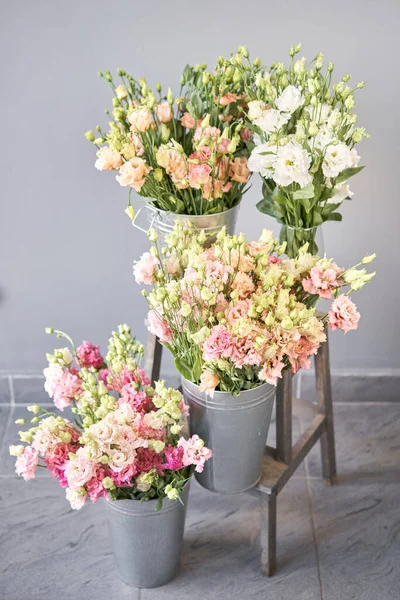 Bunches of flowers different varieties eustoma in vases. Lovely Vintage background with flowers. Wallpapers