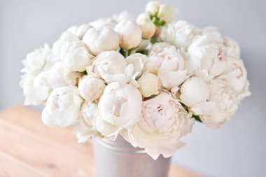 Metal bir vazoda beyaz Odile şakayıkları. Katalog ya da internet mağazası için güzel şakayık çiçekleri. Çiçek dükkanı konsepti. Taze kesilmiş güzel bir buket. Çiçek teslimatı. Boşluğu kopyala