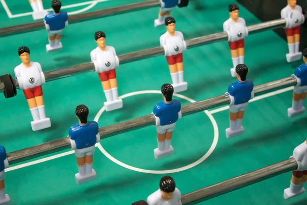 Table football game. Table soccerl with white and blue player.