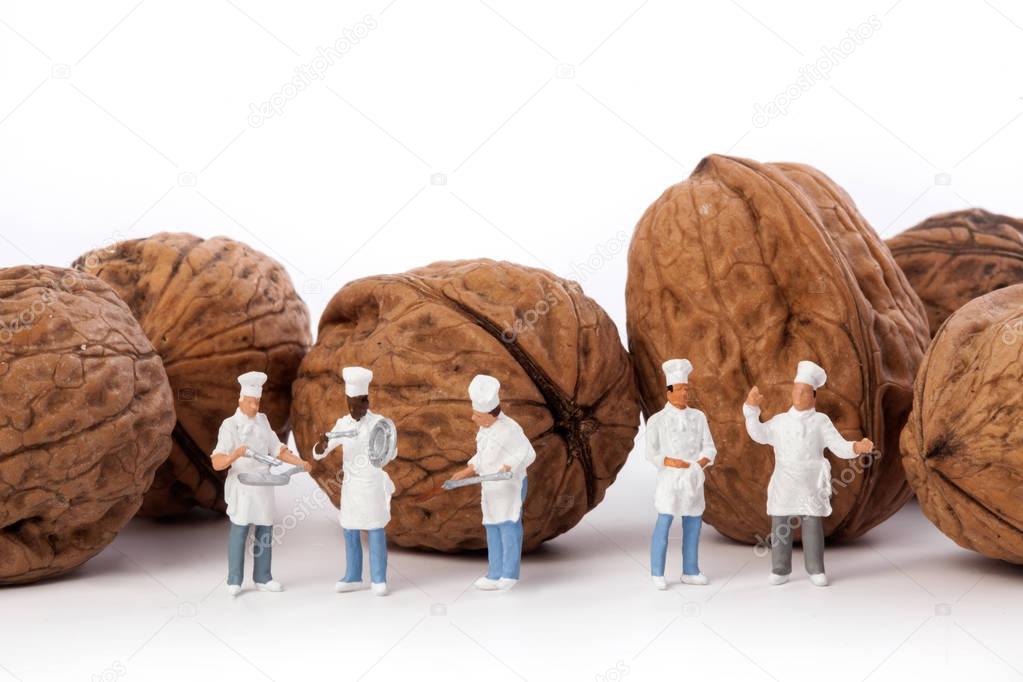  Miniature people: Chef and cooks  in front walnuts