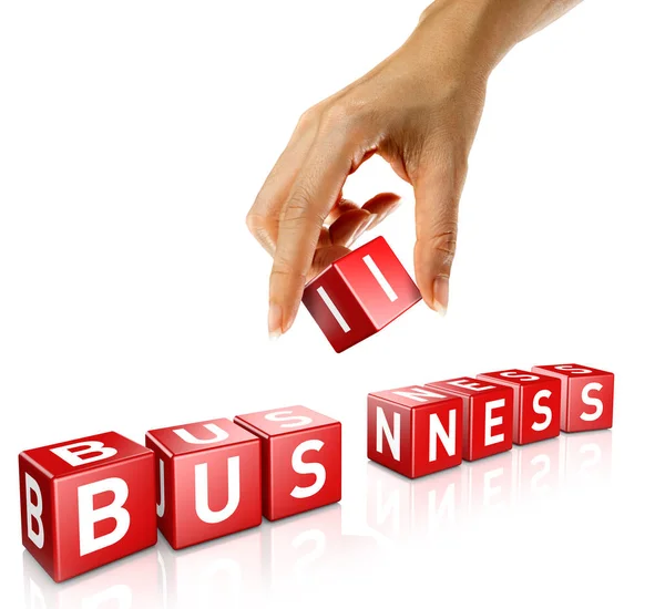 A woman's hand places a cube to form the word business — Stock Photo, Image