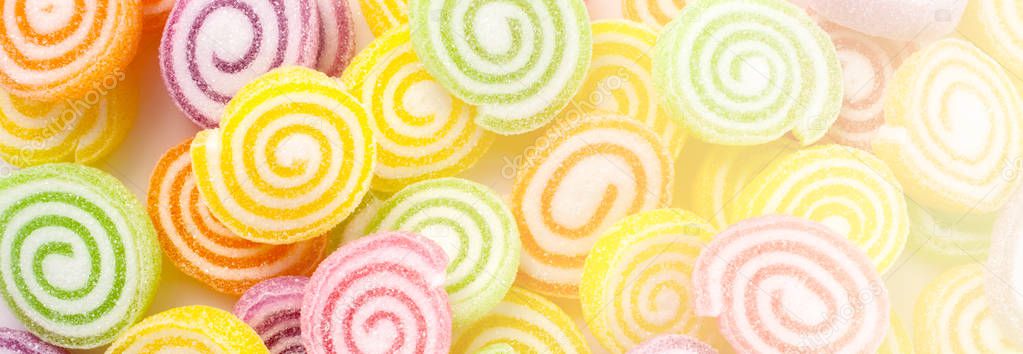closeup of colorful candies on white background - Web banner with food concept