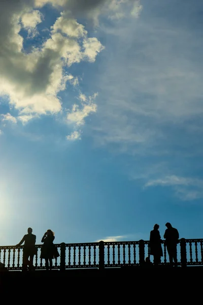 Turister nyter varmen fra våren på en bro over Seinen i Paris. . – stockfoto