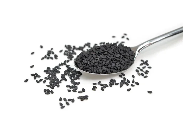 Black sesame in a spoon on white background - isolated — Stock Photo, Image