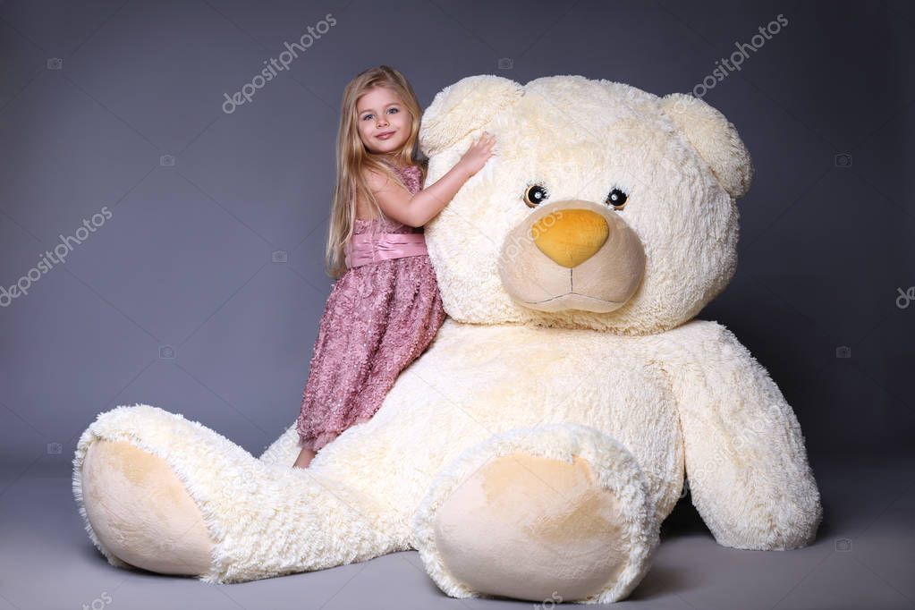 Kid hugging big plush bear