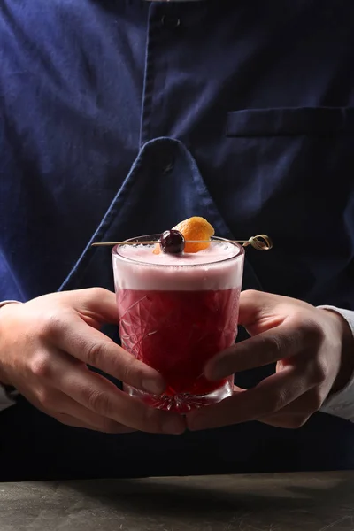 Tasty cherry cocktail in bartenders hands. Close up — Stock Photo, Image